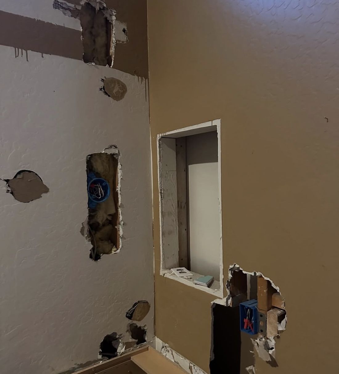 Bathroom drywall holes before repair